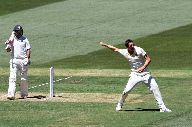 India's batsman Mayank Agarwal (L) walks back to the pavilion as Australia's paceman Pat Cummins celebrates his dismissal during day one of the third cricket Test match between Australia and India in Melbourne. (AFP)