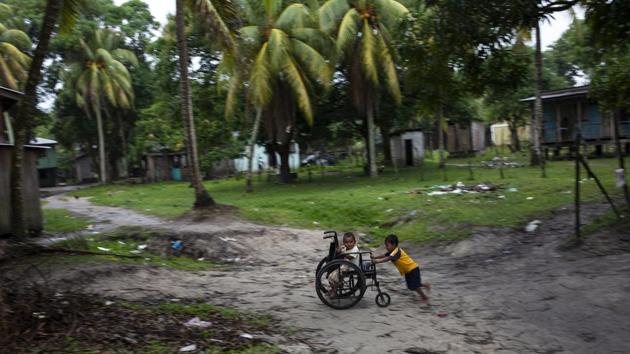 Charles Melendez, 5, and his 4-year-old brother Jefferson, play with their father’s wheelchair while he rests. A study more than a decade ago cited by the Pan American Health Organization reported there were around 9,000 divers in the Mosquitia, and around 4,200 --47%-- were disabled by decompression sickness. Atiliano said he expects to return to sea, not because he wants to, but for lack of options. (Rodrigo Abd / AP)