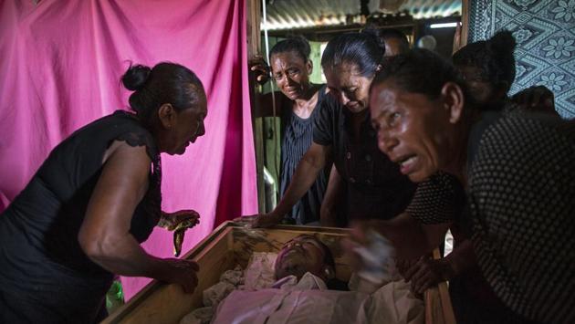 Sonia Wills (L), accompanied by relatives, mourns over the coffin of her 31-year-old son Oscar Salomon Charly, during a wake in her home. Just how many have been stricken is somewhat unclear, though it’s a large number for such small communities. Jorge Gomez Santos, a former president of the Association of Disabled Honduran Miskito Divers, said at least 1,300 have been disabled since 1980, 14 have died this year alone. (Rodrigo Abd / AP)