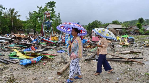 Hartati (L), whose house was destroyed by the tsunami, walks with a relative in the Sumber Jaya village in Sumur, Banten province. (Adek Berry / AFP) Hartati (L), whose house was destroyed by the tsunami, walks with a relative in the Sumber Jaya village in Sumur, Banten province. (Adek Berry / AFP)