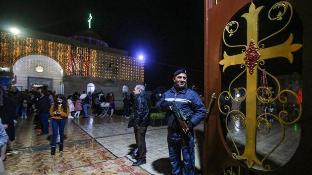 Iraqi policemen stand on guard outside the Syriac Catholic Church of Mar Jacob al Muqataa in the predominantly Iraqi Christian town of Qaraqosh, in Niniveh province some 30 kilometres from Mosul, on December 25. (AFP Photo) Iraqi policemen stand on guard outside the Syriac Catholic Church of Mar Jacob al Muqataa in the predominantly Iraqi Christian town of Qaraqosh, in Niniveh province some 30 kilometres from Mosul, on December 25. (AFP Photo)