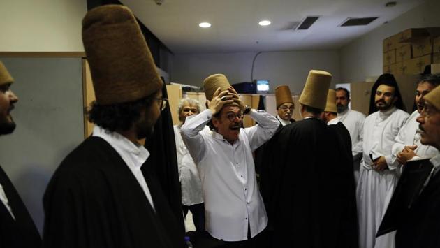 Prior to the Sheb-i Arus ceremony, whirling dervishes enjoy a light moment in the locker room as they gear up for the performance. Most dervishes are men. Some Sufi lodges, however, began to allow women to join in the early 2000s. (Lefteris Pitarakis / AP Photo) Prior to the Sheb-i Arus ceremony, whirling dervishes enjoy a light moment in the locker room as they gear up for the performance. Most dervishes are men. Some Sufi lodges, however, began to allow women to join in the early 2000s. (Lefteris Pitarakis / AP Photo)