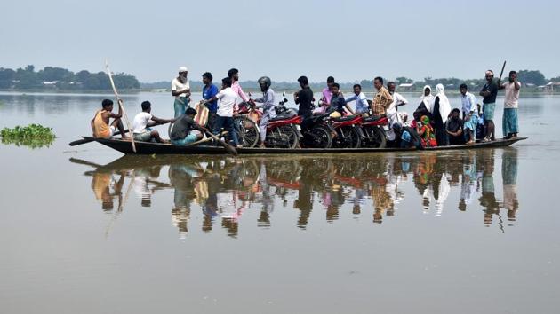 Villagers use a boat to travel after the situation deteriorated due to the state’s annual flooding, exacerbated by seasonal rains, at Ashigarh village in Morigaon District of Assam. (Rajib Jyoti Sarma / HT Photo) 