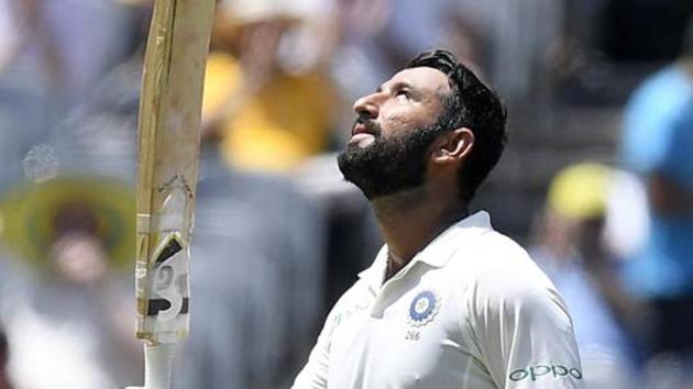 India's Cheteshwar Pujara celebrates scoring a century during play on day two of the third cricket test between India and Australia in Melbourne, Australia, Thursday, Dec. 27, 2018.(AP)