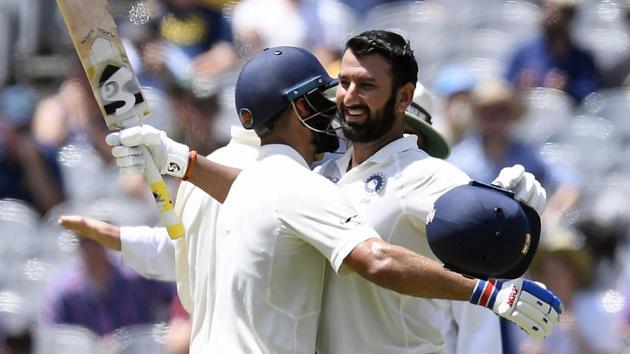 India's Cheteshwar Pujara, right is congratulated by team mate Virat Kohli after scoring a century during play on day two of the third cricket test between India and Australia in Melbourne. (AP) India's Cheteshwar Pujara, right is congratulated by team mate Virat Kohli after scoring a century during play on day two of the third cricket test between India and Australia in Melbourne. (AP)