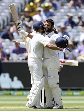India's Cheteshwar Pujara, right is congratulated by team mate Virat Kohli after scoring a century during play on day two of the third cricket test between India and Australia in Melbourne (AP) India's Cheteshwar Pujara, right is congratulated by team mate Virat Kohli after scoring a century during play on day two of the third cricket test between India and Australia in Melbourne (AP)