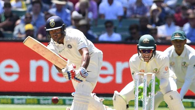 India's Mayank Agarwal (L) plays a shot as Australia's Tim Paine (C) and Usman Khawaja look on during day one of the third test match between Australia and India at the MCG.(REUTERS)