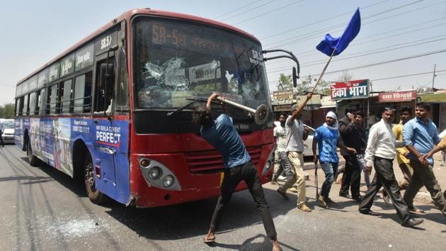 Members of a Dalit organisation damage a bus during Bharat Bandh in Bhopal, Madhya Pradesh. Several Dalit groups had called for a ‘Bharat Bandh’ in April, demanding restoration of the Scheduled Castes/Scheduled Tribes (Prevention of Atrocities) Act to its original form. The Bandh was a call highlighting latent resentment among the community. (Mujeeb Faruqui / HT Photo) 