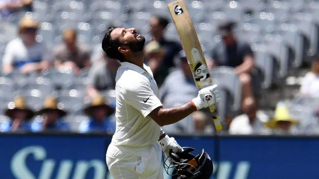 India's batsman Cheteshwar Pujara (C) celebrates reaching his century (100 runs) during day two of the third cricket Test match between Australia and India in Melbourne(AFP)