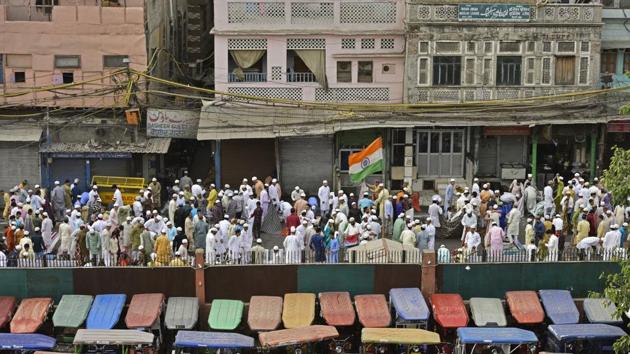 People greet each other after offering the ceremonial prayers on the occasion of Eid-ul-Fitr outside Jama Masjid in Old Delhi. (Anushree Fadnavis / HT Photo) 