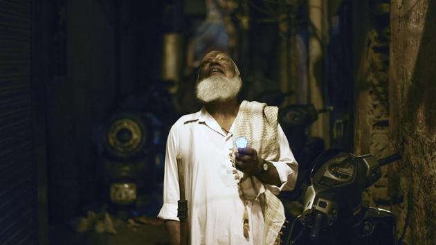 Nawabuddin, 75, or ‘Peer ji’, is seen roaming the streets at night to wake devotees for the pre-dawn sehri meal in the month of Ramzan in the old quarters of Delhi. Criers like Nawabuddin are a dying breed, continuing a tradition from times before the alarm clock took over. (Burhaan Kinu / HT Photo) 