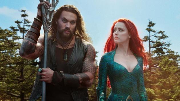 This image released by Warner Bros. Pictures shows Jason Momoa, left, and Amber Heard in a scene from Aquaman.(AP)