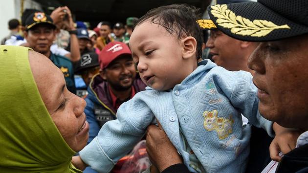 A mother and her infant disembark from a ferry after being evacuated from Sebesi Island, in Lampung province after the December 22 tsunami which hit the west coast of Indonesia’s Java island. The country’s search and rescue teams plucked stranded residents from remote islands, pushing into isolated communities desperate for aid in the aftermath of the volcano-triggered tsunami that killed over 430, with 1,495 injured and 159 missing. (Mohd Rasfan / AFP) A mother and her infant disembark from a ferry after being evacuated from Sebesi Island, in Lampung province after the December 22 tsunami which hit the west coast of Indonesia’s Java island. The country’s search and rescue teams plucked stranded residents from remote islands, pushing into isolated communities desperate for aid in the aftermath of the volcano-triggered tsunami that killed over 430, with 1,495 injured and 159 missing. (Mohd Rasfan / AFP)