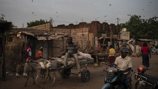 People ride a donkey cart on a street after sunset in Goudiry. She recently put on the veil of a widow and now must stay at home until a mourning period of four months and 10 days comes to a close. Mariama will not change clothes, work in the fields or eat meals with her husband’s family. (Felipe Dana / AP) People ride a donkey cart on a street after sunset in Goudiry. She recently put on the veil of a widow and now must stay at home until a mourning period of four months and 10 days comes to a close. Mariama will not change clothes, work in the fields or eat meals with her husband’s family. (Felipe Dana / AP)