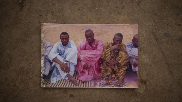 A print of Tidiane Fofana (C), sitting with friends in Goudiry, Senegal. “My child said to me, ‘If we don’t leave, how can things change?’” Tidiane followed his older brother to Libya and then called in 2015 to say he would soon be crossing the Mediterranean. (Felipe Dana / AP) A print of Tidiane Fofana (C), sitting with friends in Goudiry, Senegal. “My child said to me, ‘If we don’t leave, how can things change?’” Tidiane followed his older brother to Libya and then called in 2015 to say he would soon be crossing the Mediterranean. (Felipe Dana / AP)