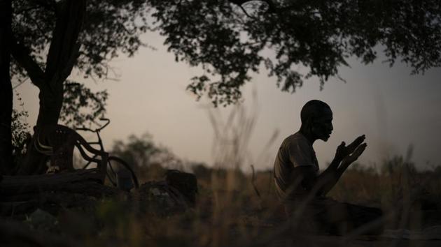 Fofana works his fields alone every day. It is there where he prays, and there where he wonders what happened to his son. His wife is resigned — four years is a long time, she tells him. But he won’t let her carry out a sacrifice yet. (Felipe Dana / AP) Fofana works his fields alone every day. It is there where he prays, and there where he wonders what happened to his son. His wife is resigned — four years is a long time, she tells him. But he won’t let her carry out a sacrifice yet. (Felipe Dana / AP)