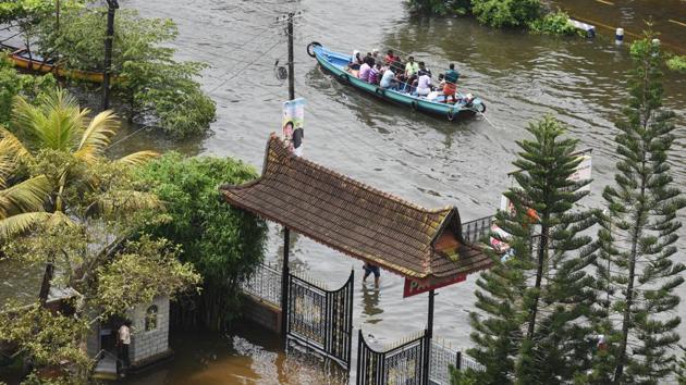 Volunteers rescue people from a flooded residential area at Alappuzha district, in Kerala. Extreme rainfall and flooding devastated Kerala in August, the worst disaster the state confronted in almost a century. A meteorological analysis of the event by the ministry of earth sciences (MoES) later concluded it as a result of climate change. (Raj K Raj / HT Photo) 