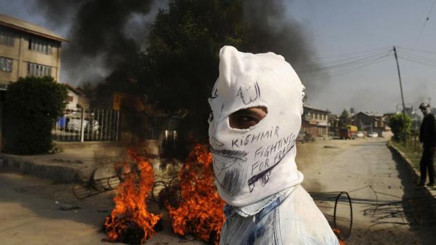 A masked protester looks on during clashes in downtown, Srinagar, Jammu and Kashmir. (Waseem Andrabi / HT Photo) 