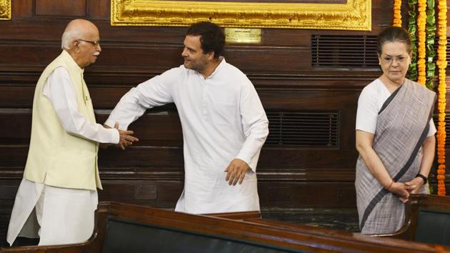 Congress President Rahul Gandhi guides senior BJP leader L K Advani as UPA chairperson Sonia Gandhi looks on after paying floral tribute to late Prime Minister Rajiv Gandhi on his birth anniversary at the central hall of Parliament House in New Delhi. (Mohd Zakir / HT Photo) 