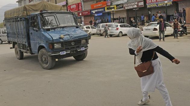 A college student pelts a stone onto a police vehicle during clashes outside a college while protesting against killings in the state, in Srinagar, Jammu and Kashmir. In countless protests against civilian killings or during demonstrations of anti-India sentiments, the participation of Kashmir girl students was a noted occurrence this year. (Waseem Andrabi / HT Photo) 