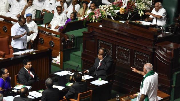 BJP Karnataka President BS Yeddyurappa (R) and Chief Minister HD Kumarswamy speak to each other before the former walked out of Karnataka Assembly with his MLAs at Vidhana Soudha in Bengaluru, Karnataka. This spectacle of an election saw alliances, confidence votes and stakes to governments failing, all in a span of a few days. (Arijit Sen / HT Photo) 