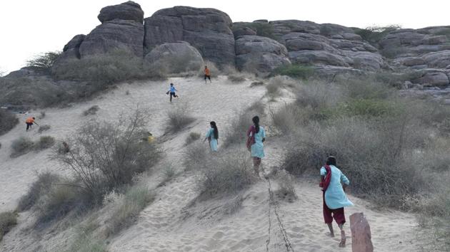 Popularly known as ‘Ret ka Tila’ (sand dune), girls from the Veerni Institute run up the mound in the evening after classes to play, in Jodhpur, Rajasthan. The institute offers thee girls, from diverse economic and social backgrounds, an escape from the patriarchal societal rigor. (Anushree Fadnavis / HT Photo) 