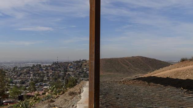 Tijuana, Mexico (L), and San Diego, California (R), are seen separated by the US border fence. The US federal government is expected to remain partially closed past Christmas Day in a protracted standoff over President Donald Trump's demand for money to build a border wall with Mexico. (Daniel Ochoa de Olza / AP) Tijuana, Mexico (L), and San Diego, California (R), are seen separated by the US border fence. The US federal government is expected to remain partially closed past Christmas Day in a protracted standoff over President Donald Trump's demand for money to build a border wall with Mexico. (Daniel Ochoa de Olza / AP)