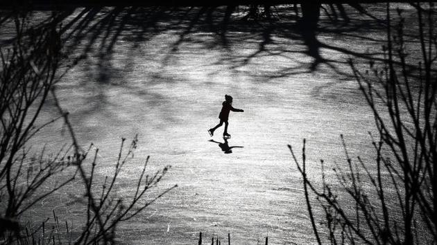 A girl skates across a frozen pond in Freeport, Maine. Last week's rain washed away much of the snow in southern Maine, but the return of cold temperatures helped create ideal outdoor skating conditions. (Robert F. Bukaty / AP) A girl skates across a frozen pond in Freeport, Maine. Last week's rain washed away much of the snow in southern Maine, but the return of cold temperatures helped create ideal outdoor skating conditions. (Robert F. Bukaty / AP)