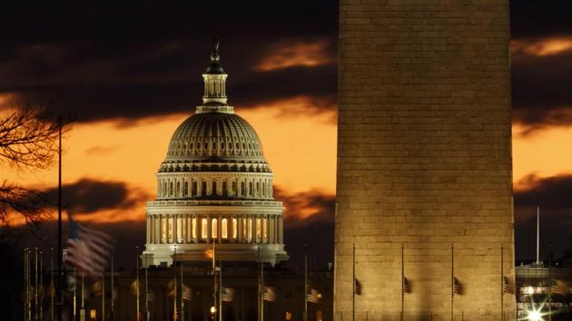 The US Capitol dome is seen past the base of the Washington Monument just before sunrise in Washington. (Carolyn Kaster / AP) The US Capitol dome is seen past the base of the Washington Monument just before sunrise in Washington. (Carolyn Kaster / AP)