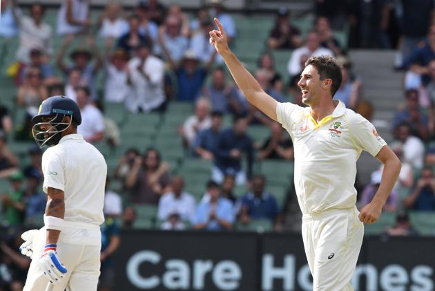 Australia's Pat Cummins reacts after dismissing India's captain Virat Kohli (L) on day three of the third test match between Australia and India at the MCG in Melbourne. (REUTERS)
