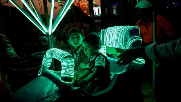 Children enjoy a ride at a fair in Mumbai, Maharashtra. (Danish Siddiqui / REUTERS) Children enjoy a ride at a fair in Mumbai, Maharashtra. (Danish Siddiqui / REUTERS)
