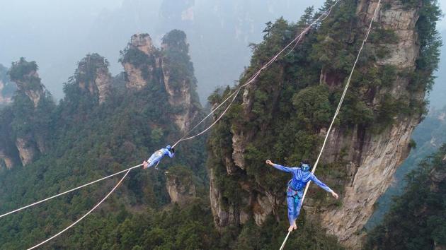 Contestants dressed as characters from the movie "Avatar" take part in a tightrope walking contest in Wulingyuan Scenic Area of Zhangjiajie, Hunan province, China. (REUTERS) Contestants dressed as characters from the movie "Avatar" take part in a tightrope walking contest in Wulingyuan Scenic Area of Zhangjiajie, Hunan province, China. (REUTERS)