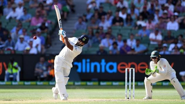 India's batsman Rishabh Pant plays a shot as Australia's wicketkeeper Tim Paine (R) looks on during day three of the third cricket Test match between Australia and India in Melbourne on December 28, 2018.(AFP)