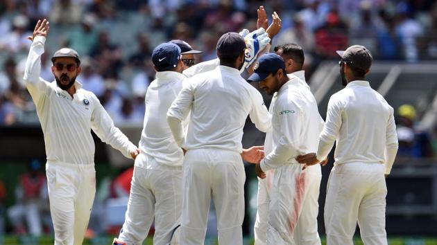Indian cricketers celebrate the dismissal of Australia's batsman Pat Cummins during day three of the third cricket Test match between Australia and India in Melbourne. (AFP)