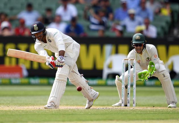 India's batsman Mayank Agarwal (L) plays a shot as Australia's wicketkeeper Tim Paine looks on during day three of the third cricket Test match between Australia and India in Melbourne. (AFP)