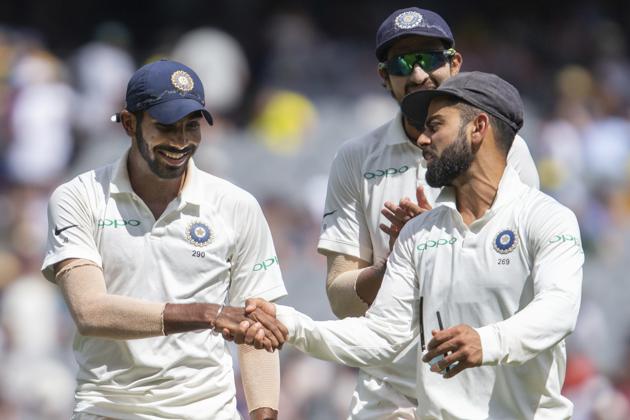 India's captain Virat Kohli, right, shakes hands with Jasprit Bumrah after Bumrah got 6 wickets during play on day three of the third cricket test between India and Australia in Melbourne. (AP)