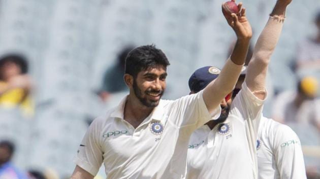 Jasprit Bumrah, left, raises the ball after getting his fifth wicket.(AP)