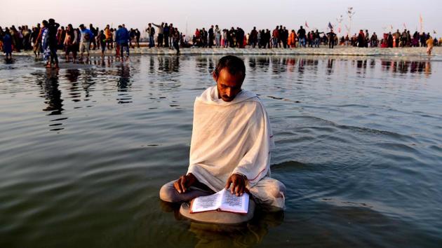 A man reads the Bhagavad Gita, one of the major scriptures of Hinduism, while sitting in the water at Sangam during Kumbh Mela, in Prayagraj, Uttar Pradesh. (PTI) A man reads the Bhagavad Gita, one of the major scriptures of Hinduism, while sitting in the water at Sangam during Kumbh Mela, in Prayagraj, Uttar Pradesh. (PTI)