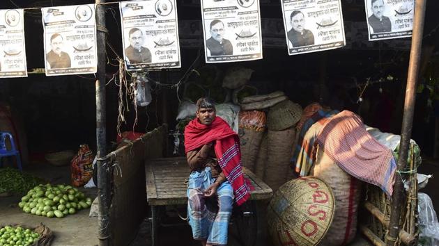 A Bangladeshi man sits on his rickshaw van as posters of the ruling Bangladesh Awami League election candidates hang above him at a market in Dhaka. (Munir Uz Zaman / AFP) A Bangladeshi man sits on his rickshaw van as posters of the ruling Bangladesh Awami League election candidates hang above him at a market in Dhaka. (Munir Uz Zaman / AFP)
