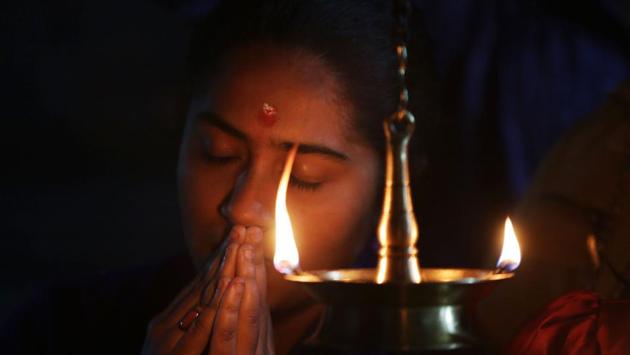 A girl worships Aiyappa Swami as she performs a Mandala Pooja during the Mandalam Makar Vilakku festival at Aiyappa Temple in Bhopal, Madhya Pradesh. (Gagan Nayar / AFP) A girl worships Aiyappa Swami as she performs a Mandala Pooja during the Mandalam Makar Vilakku festival at Aiyappa Temple in Bhopal, Madhya Pradesh. (Gagan Nayar / AFP)