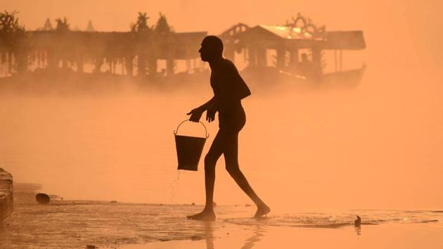 A Hindu devotee carries a bucket of water from Narmada river in Jabalpur, Madhya Pradesh. (AFP) A Hindu devotee carries a bucket of water from Narmada river in Jabalpur, Madhya Pradesh. (AFP)