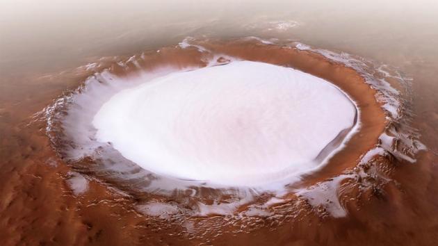 Korolev crater, in the northern lowlands of Mars. The crater is an especially well-preserved example of a martian crater and is filled not by snow but ice, with its centre hosting a mound of water ice some 1.8 kilometres thick all year round. (ESA Handout / AFP) Korolev crater, in the northern lowlands of Mars. The crater is an especially well-preserved example of a martian crater and is filled not by snow but ice, with its centre hosting a mound of water ice some 1.8 kilometres thick all year round. (ESA Handout / AFP)
