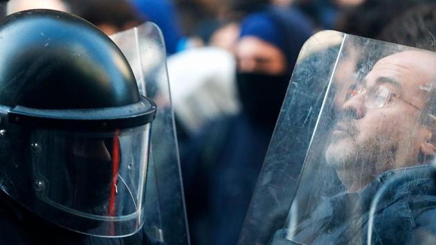 A member of the Catalan regional police force Mossos d’Esquadra scuffles with a man as police try to keep protesters behind crowd control barricades during a Catalan pro-independence demonstration in Barcelona as the Spanish cabinet held a meeting in the city. (Pau Barrena / AFP) A member of the Catalan regional police force Mossos d’Esquadra scuffles with a man as police try to keep protesters behind crowd control barricades during a Catalan pro-independence demonstration in Barcelona as the Spanish cabinet held a meeting in the city. (Pau Barrena / AFP)