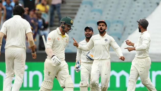 India's captain Virat Kohli (2nd R) celebrates after his teammate Ishant Sharma (L) took the wicket of Australia's Travis Head (2nd L) on day four of the third test match between Australia and India at the MCG in Melbourne. (REUTERS)