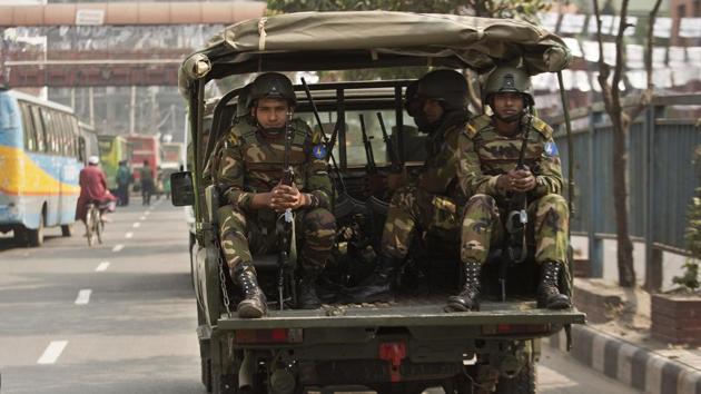 Bangladeshi army soldiers sit inside a vehicle as they patrol the streets on the eve of the general elections in Dhaka, Bangladesh on December 29.(AP Photo)