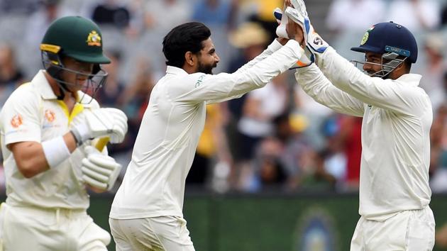 India's bowler Ravindra Jadeja (C) celebrates taking a wicket of Australia's batsman Marcus Harris (L) with teammate Rishabh Pant during day four of the third cricket Test match between Australia and India in Melbourne. (AFP)