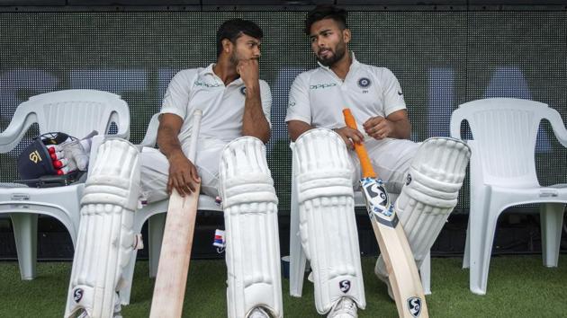 India's Mayank Agarwal, left, and Rishabh Pant sit on the bench before the start of play on day four of the third cricket test between India and Australia in Melbourne. (AP)