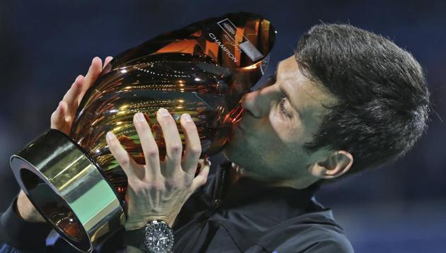 Serbia's Novak Djokovic kisses the trophy after he defeated South Africa's Kevin Anderson in the final.(AP)