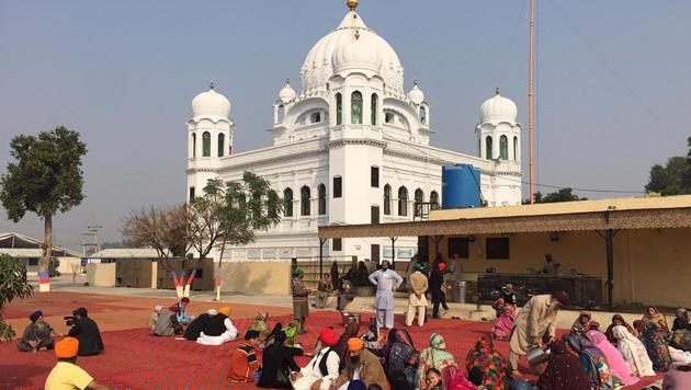 Sikh pilgrims sit in front of Kartarpur Gurdwara Sahib before a groundbreaking ceremony for the Kartarpur Corridor in November.(AFP file photo)