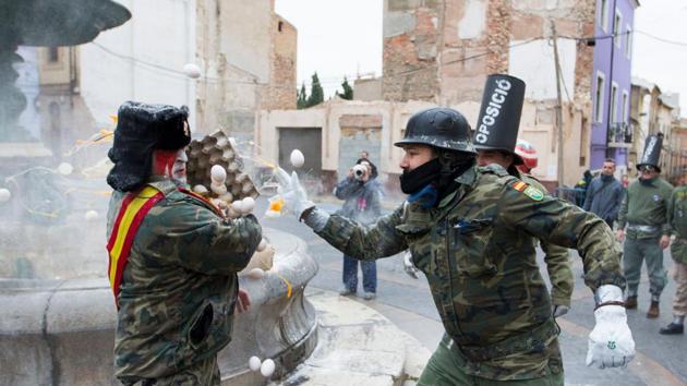 The name Els Enfarinats derives from the Valencian word for “breading”, roughly translating to “the breaded ones” or “the floured ones”. (Jaime Reina / AFP) The name Els Enfarinats derives from the Valencian word for “breading”, roughly translating to “the breaded ones” or “the floured ones”. (Jaime Reina / AFP)